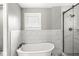 Bathroom featuring a soaking tub and tile surround shower with glass door at 4575 N Guilford Ave, Indianapolis, IN 46205
