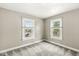 A cozy bedroom features two bright windows and neutral-toned walls at 4575 N Guilford Ave, Indianapolis, IN 46205