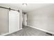 Bedroom with a barn door and plush carpet at 4575 N Guilford Ave, Indianapolis, IN 46205