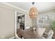The dining room features a modern light fixture and a view of the kitchen at 4575 N Guilford Ave, Indianapolis, IN 46205