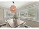 A dining room has a modern chandelier fixture, ample natural light, and space for entertaining at 4575 N Guilford Ave, Indianapolis, IN 46205