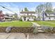 Quaint home with a stone foundation and walkway bordered by purple flowers at 4575 N Guilford Ave, Indianapolis, IN 46205