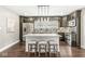 A kitchen with granite countertops, an island with seating, stainless steel appliances, and modern pendant lighting at 4575 N Guilford Ave, Indianapolis, IN 46205