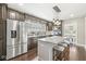 A kitchen boasts stainless steel appliances, granite countertops, stylish island with seating, and open access to the dining area at 4575 N Guilford Ave, Indianapolis, IN 46205