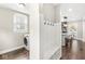 Mud room with built-in bench and storage cubbies, with view to the nearby kitchen at 4575 N Guilford Ave, Indianapolis, IN 46205