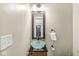 Stylish powder room featuring a vessel sink, updated fixtures, and a decorative mirror at 4575 N Guilford Ave, Indianapolis, IN 46205