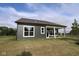 Beautiful backyard exterior features large windows, gray siding and a covered patio for relaxation and entertaining at 5052 Carmine St, Brownsburg, IN 46112