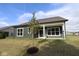View of the backyard featuring a covered patio, gray siding and large windows to maximize natural light at 5052 Carmine St, Brownsburg, IN 46112