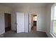 Bedroom showcasing multiple doorways and a window with natural light at 5052 Carmine St, Brownsburg, IN 46112
