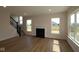 Inviting living room with natural light, fireplace, and staircase, creating a cozy ambiance at 5052 Carmine St, Brownsburg, IN 46112