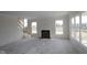 Spacious living room featuring fireplace, large windows, and stairs to the second floor at 5052 Carmine St, Brownsburg, IN 46112