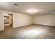 Finished basement featuring new gray carpet and bright lighting at 5130 N Washington Blvd, Indianapolis, IN 46205