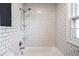 Bright bathroom featuring white subway tile and shower with shelves at 5130 N Washington Blvd, Indianapolis, IN 46205