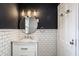 Stylish bathroom features a modern round mirror and marble vanity at 5130 N Washington Blvd, Indianapolis, IN 46205