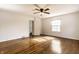 Spacious bedroom with hardwood floors, a ceiling fan, and ample natural light at 5130 N Washington Blvd, Indianapolis, IN 46205