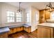 Charming breakfast nook with built-in bench seating, hardwood floors, and a view of the backyard at 5130 N Washington Blvd, Indianapolis, IN 46205