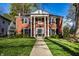 Stunning brick home featuring a columned entryway and lush green lawn at 5130 N Washington Blvd, Indianapolis, IN 46205