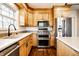 Modern kitchen boasting stainless steel appliances, custom cabinets, quartz countertops, and hardwood floors at 5130 N Washington Blvd, Indianapolis, IN 46205