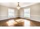 Bright living room showcasing hardwood floors, large windows, and a stylish chandelier at 5130 N Washington Blvd, Indianapolis, IN 46205