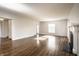 Sunlit living room boasts hardwood floors and a cozy fireplace at 5130 N Washington Blvd, Indianapolis, IN 46205