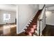 Elegant staircase featuring wood banister and carpeted steps at 5130 N Washington Blvd, Indianapolis, IN 46205