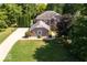 Aerial view of a beautiful brick home with lush landscaping and a circular driveway at 5773 Station Hill Dr, Avon, IN 46123