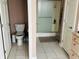 A bathroom featuring a toilet and a glass shower behind a half wall at 5773 Station Hill Dr, Avon, IN 46123