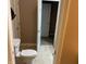 Powder room featuring a toilet and a sink with a mirrored door visible beyond at 5773 Station Hill Dr, Avon, IN 46123
