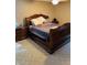 Bedroom with a king-size wooden bed, matching nightstands, carpeted floor and a ceiling fan at 5773 Station Hill Dr, Avon, IN 46123
