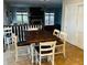 Dining area with wooden table and chairs, with a view into the living room at 5773 Station Hill Dr, Avon, IN 46123