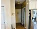 Hallway leading to rooms with neutral paint and a stainless steel refrigerator at 5773 Station Hill Dr, Avon, IN 46123