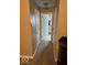 Hallway with neutral-toned walls and carpet, with doorways leading to other rooms at 5773 Station Hill Dr, Avon, IN 46123