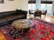 Cozy living room featuring hardwood floors, a leather sofa, and an elegant area rug, perfect for relaxation at 5773 Station Hill Dr, Avon, IN 46123