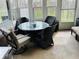 Sunroom featuring a glass top table with 4 chairs and multiple windows at 5773 Station Hill Dr, Avon, IN 46123