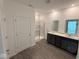 New bathroom with double vanity, walk-in shower with glass doors, and new light fixtures at 5924 Trichel Dr, Greenwood, IN 46143