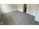 Large bedroom with neutral carpet, freshly painted white walls and two doors at 5924 Trichel Dr, Greenwood, IN 46143