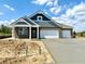 New brick home featuring a two-car garage, craftsman details and a blue-grey color scheme at 5924 Trichel Dr, Greenwood, IN 46143