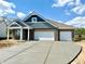 A modern home shows off its wide driveway and crisp, clean architectural lines at 5924 Trichel Dr, Greenwood, IN 46143