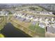 Aerial view of a home with a large backyard, bordering a lake in a suburban neighborhood at 613 Waterford Ln, Westfield, IN 46074