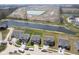 Aerial view highlighting a property in a lakeside neighborhood with nearby homes, road access, and a scenic pond at 613 Waterford Ln, Westfield, IN 46074