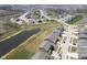 Aerial view of a neighborhood with houses lining the street near a scenic pond and extensive community development at 613 Waterford Ln, Westfield, IN 46074
