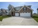 Charming two-story home with brick and gray siding, attached two-car garage, and well-manicured lawn at 613 Waterford Ln, Westfield, IN 46074
