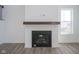 Modern fireplace with a wood mantel and white surround located in a cozy living room at 613 Waterford Ln, Westfield, IN 46074