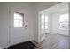 Bright foyer with hardwood floors, white trim, and views of the front yard through a white front door at 613 Waterford Ln, Westfield, IN 46074