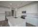 Well-lit kitchen with stainless steel appliances, countertops, and stylish cabinets at 613 Waterford Ln, Westfield, IN 46074