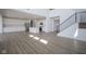 Spacious open floor plan featuring a kitchen, dining, and staircase with hardwood floors at 613 Waterford Ln, Westfield, IN 46074
