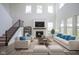Staged living room showcasing a fireplace, modern furniture, and plenty of natural light at 613 Waterford Ln, Westfield, IN 46074