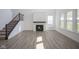 Bright living room with high ceilings, modern fireplace, staircase, and large windows at 613 Waterford Ln, Westfield, IN 46074