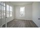 Home office bathed in natural light with hardwood floors and an entrance through double glass doors at 613 Waterford Ln, Westfield, IN 46074