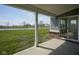 Covered patio view with a beautiful view of a pond and surrounding greenery, accessible through sliding glass doors at 613 Waterford Ln, Westfield, IN 46074